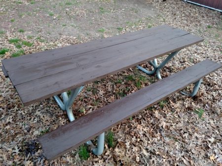 The picnic table looks like it was stolen from a park. Except that no one's carved their initials into it.